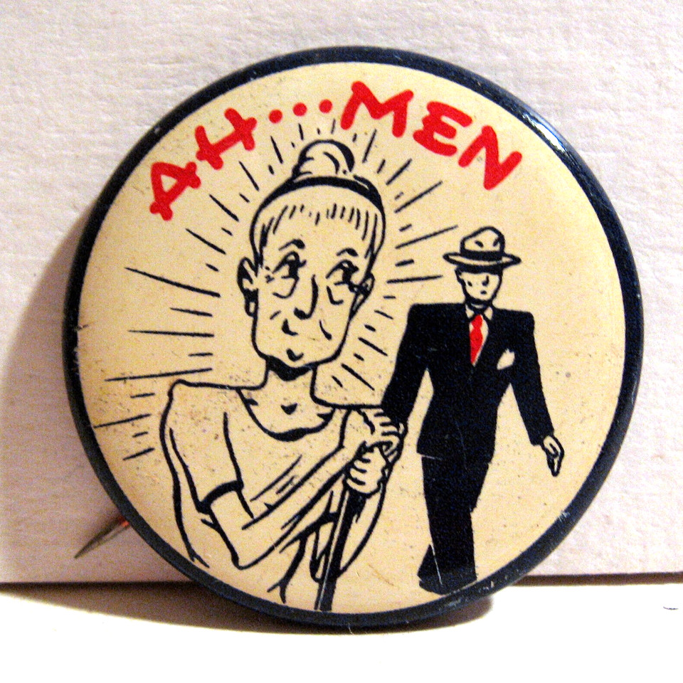 A deadpan 1940s–50s 'Ah...Men' novelty pinback on old store card — a wry, era-appropriate pun that's aged into genuine charm.