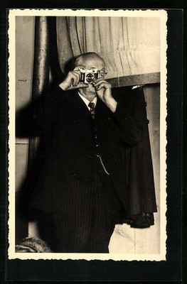 Photo postcard man looking through a camera 