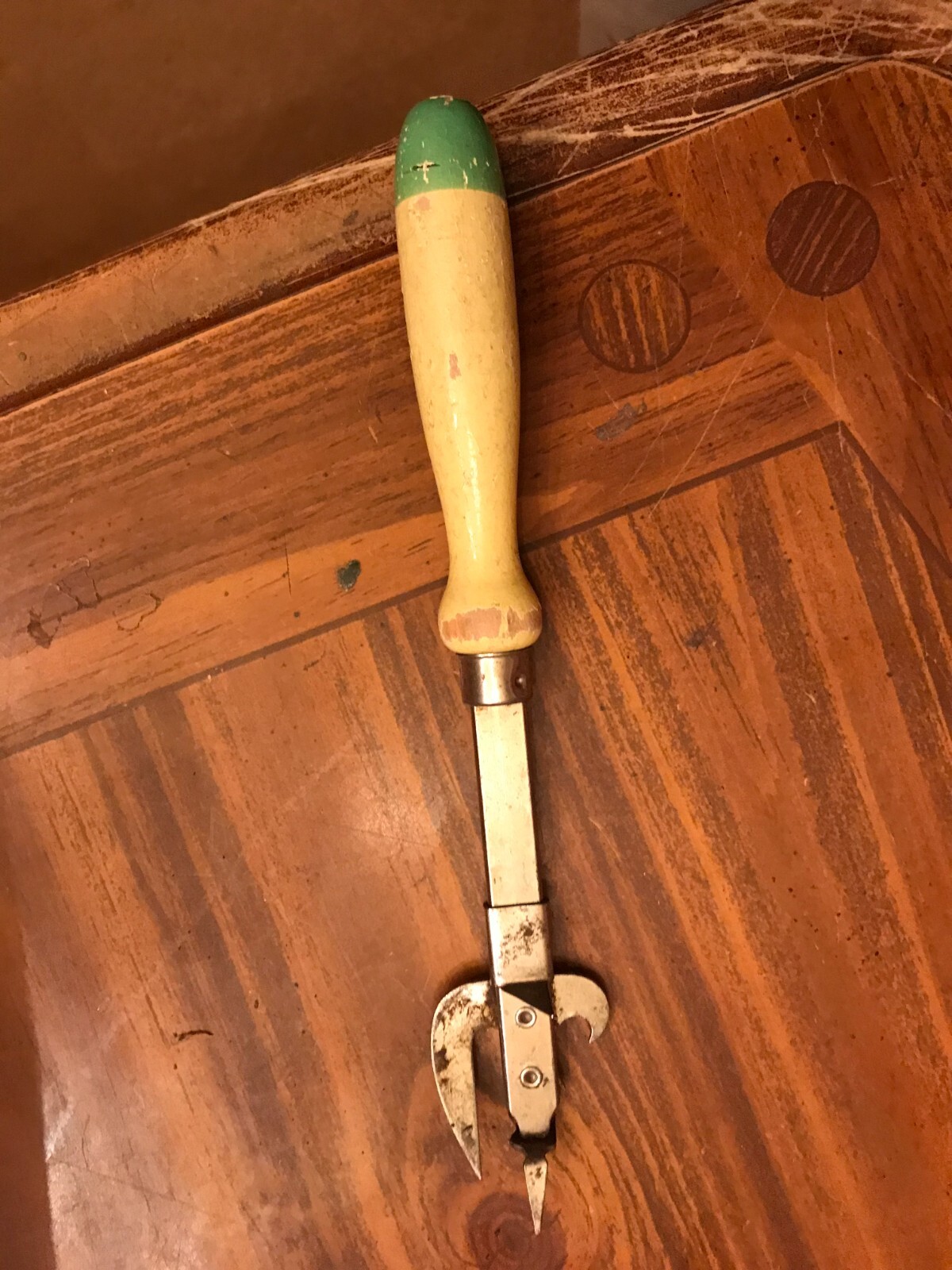 VINTAGE CAN OPENER WITH CREAM AND GREEN WOODEN HANDLE-image