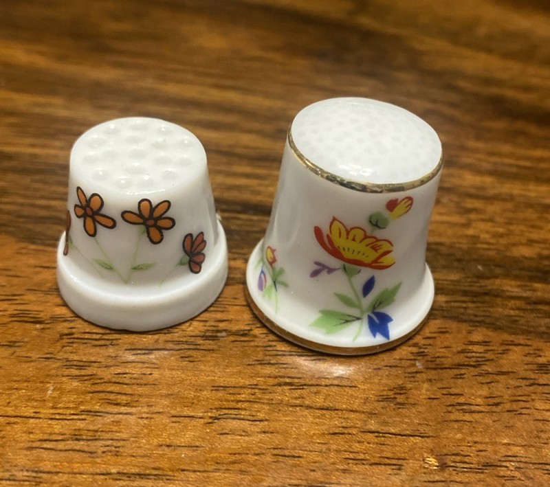 Two Ceramic Thimbles Showing Flowers Trimmed In Gold & Whimsical