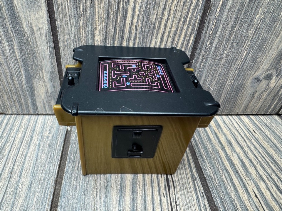 A 2.75" working retro arcade cabinet scaled perfectly for action figures — absurdly charming and instantly conversation-starting on any desk.