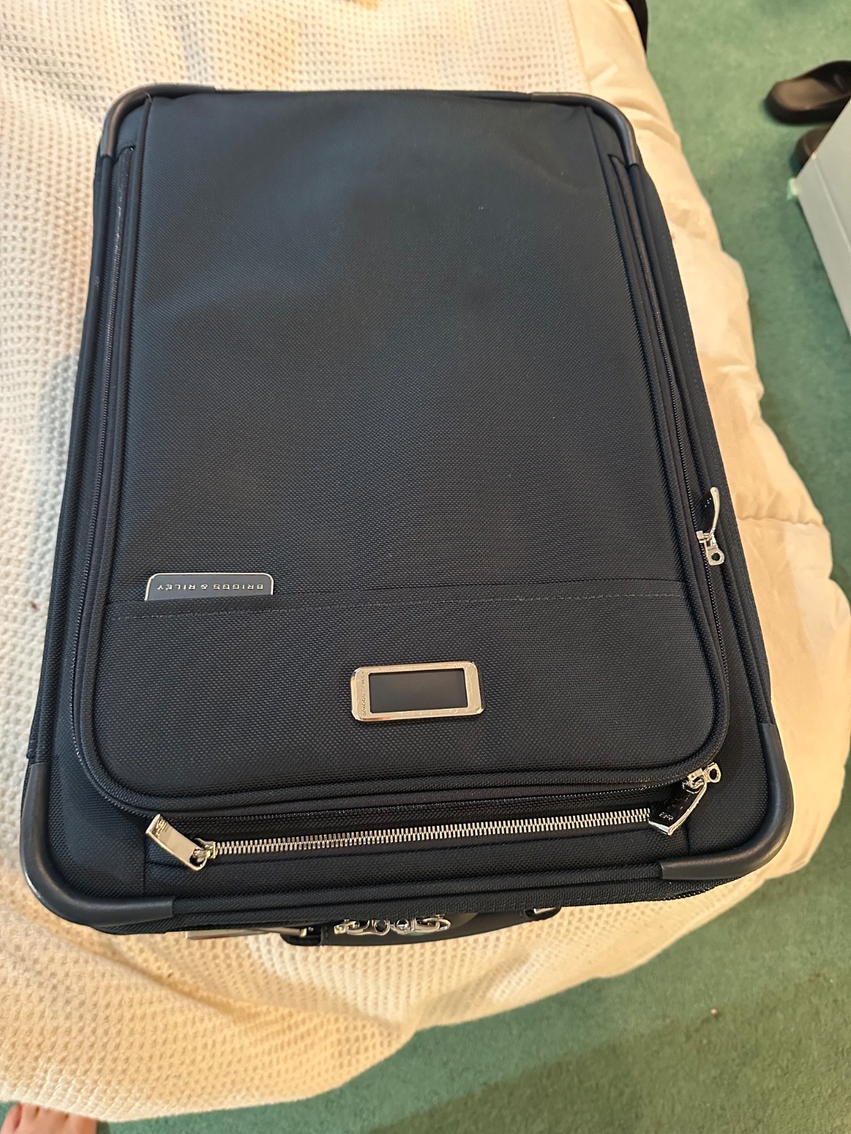 Brand-new Briggs & Riley Baseline 22” Expandable 2-Wheel Carry-On (navy). Never