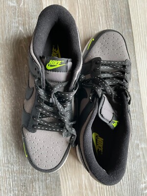 black nike shoes with green tick