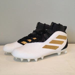 boys black and gold football cleats