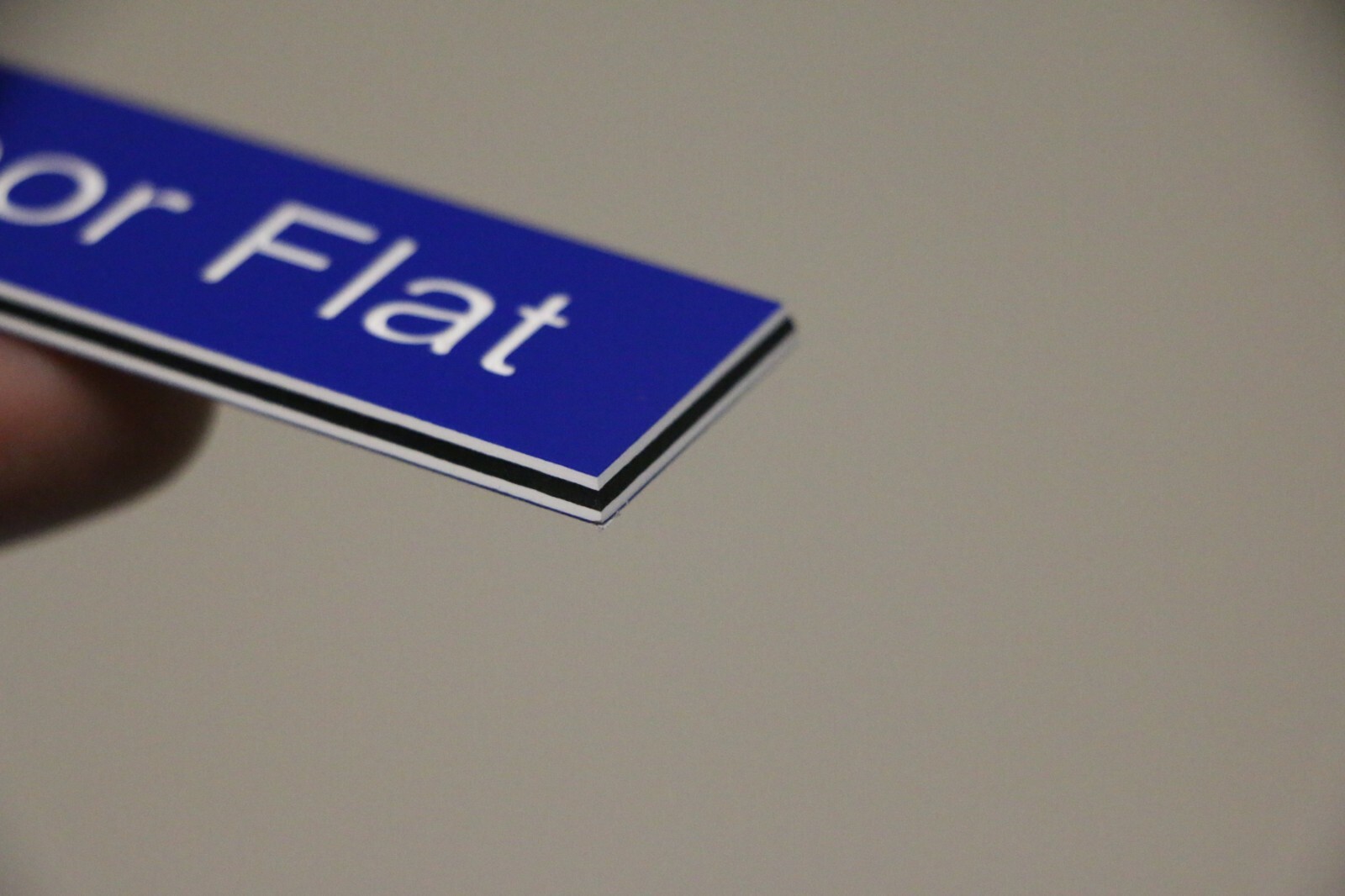 Engraved Plastic Laminate Sign 110mm x 25mm Blue Showing White