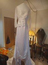 White pre-owned wedding dress size 14, with detachable train and Corset ties.