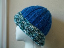 Hand knitted elegant and warm beanie/hat, blue with multi color silky trim