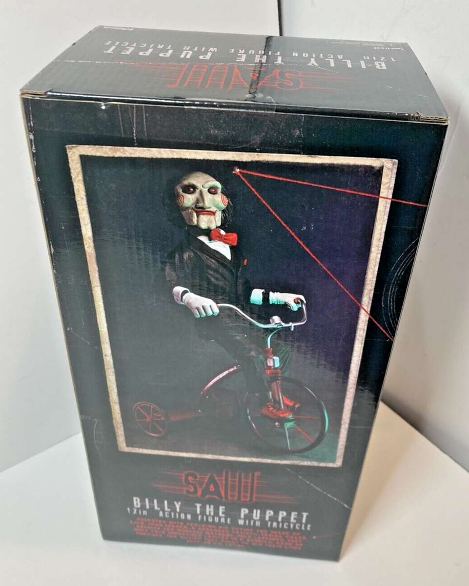 NECA Saw Billy the Puppet on Tricycle 12“ Action Figure with NECA Saw Billy the Puppet on Tricycle 12“ Action Figure with