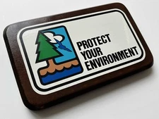 Vintage "Protect Your Environment" sticker mounted on wooden plaque wall hanging