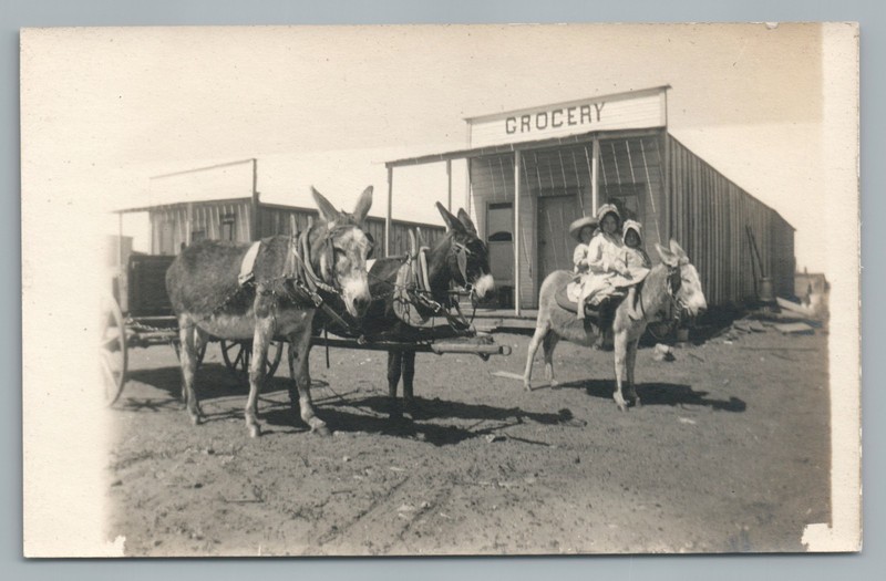 Donkey Riding Girl & Grocery Store RPPC Old West Frontier Town—Antique Photo 10s