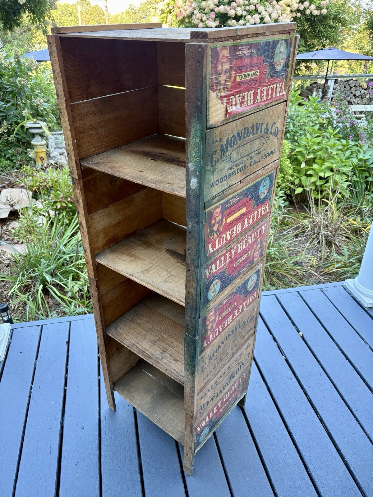 Beautiful original bookcase made out of antique farm boxes with original labels.