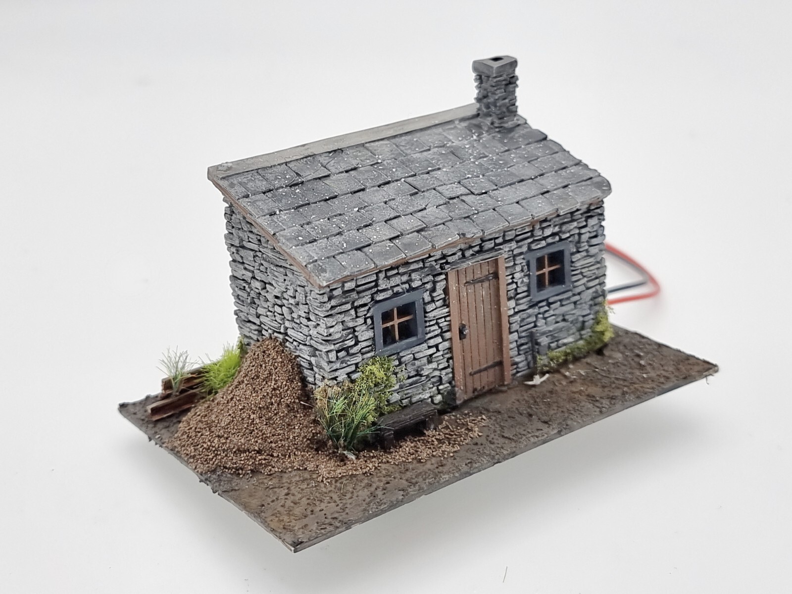 OO gauge lineside hut scene shown from a second angle, with surrounding bushes and vegetation