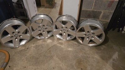 Set of 4 genuine OEM Jeep Wrangler JK alloy wheels.