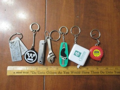 Set 7 different advertising key chains- 2 are tape measures vintage and new