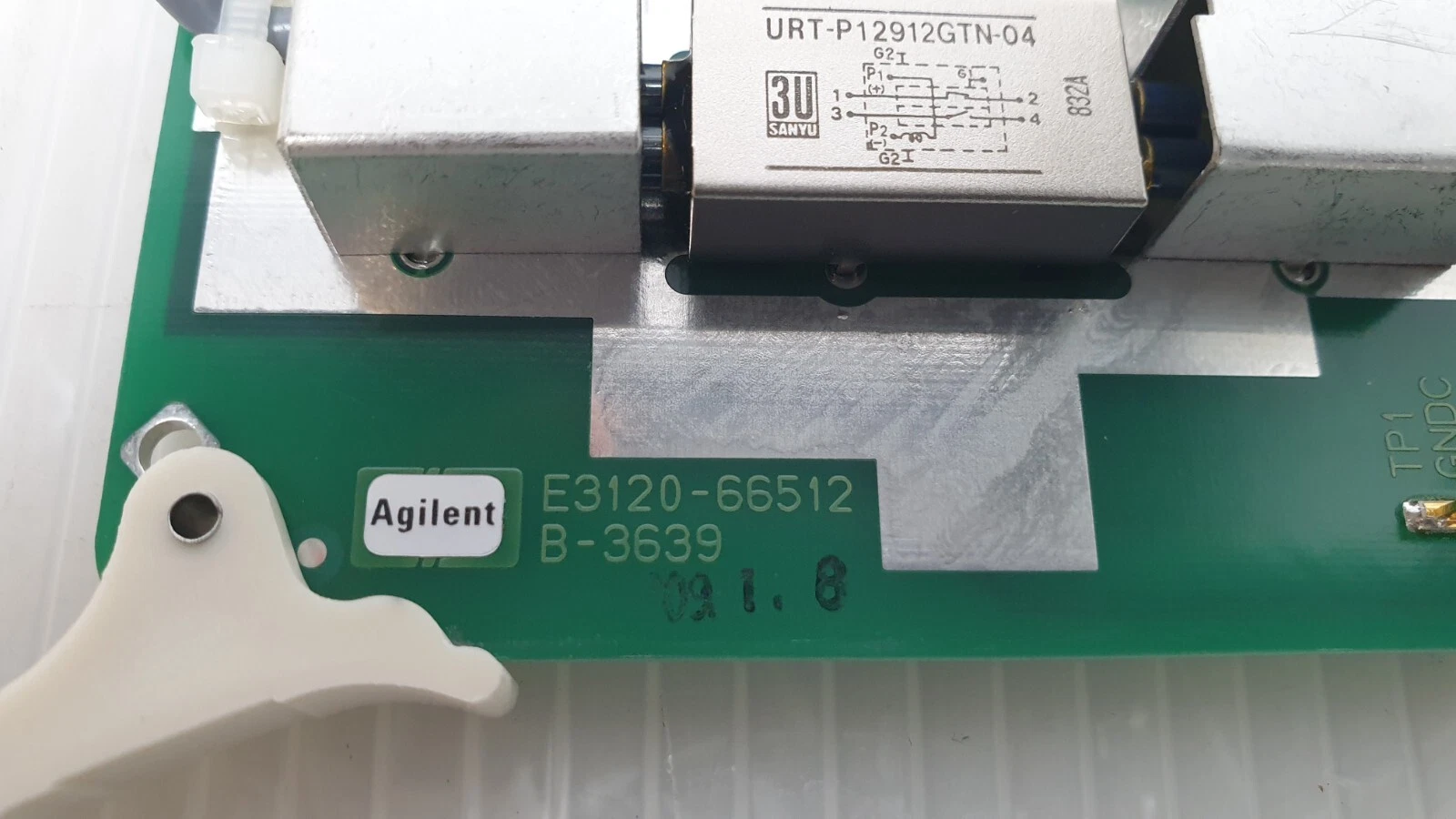 Close-up: Agilent logo, E3120-66512 B-3639 silkscreen and Sanyu URT-P12912GTN-04 relay