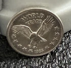 WORLD TRADE, 1 oz. .999 SILVER  ART ROUND, CIRCULATED, 1985!