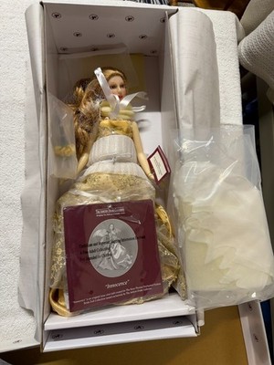 Ashton-Drake Galleries porcelain doll is dressed in a champagne-colored gown