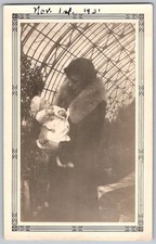 Vtg B&W Snapshot Woman In Fur Coat Holding Baby Greenhouse Conservatory 1931