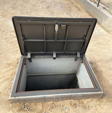 Outdoor hatch door covered with checkered tread plate Cellar basement trapdoor