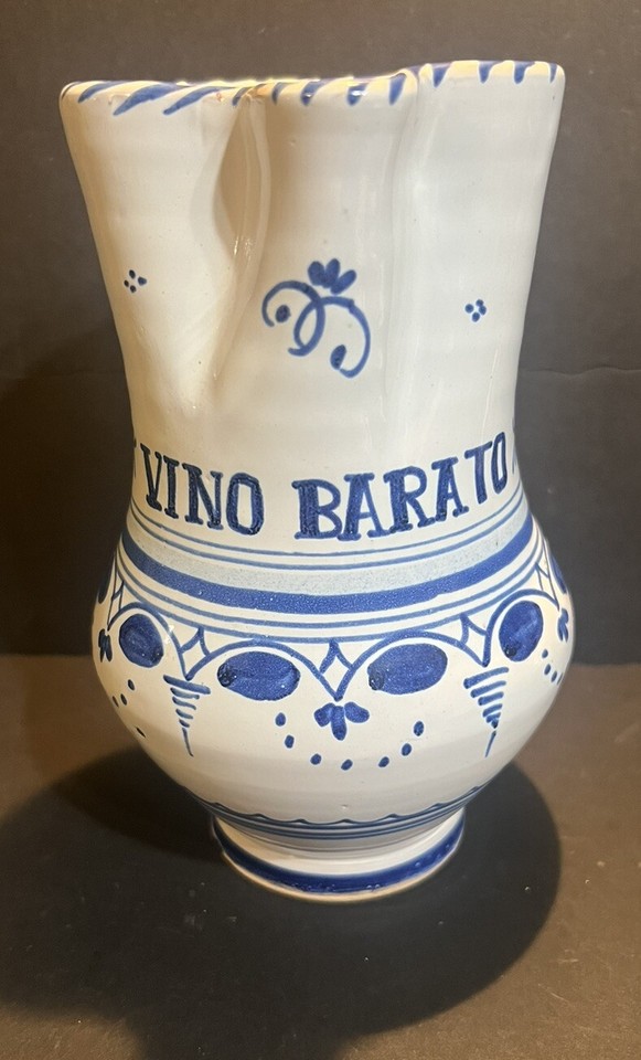 Cheerful blue-and-white ceramic pitcher with a self-deprecating 'cheap wine' inscription — charming, functional, and conversation-starting on any table.