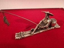 CHARMING VINTAGE WHITE METAL ORNAMENT OF AN ORIENTAL FISHERMAN ON A RAFT