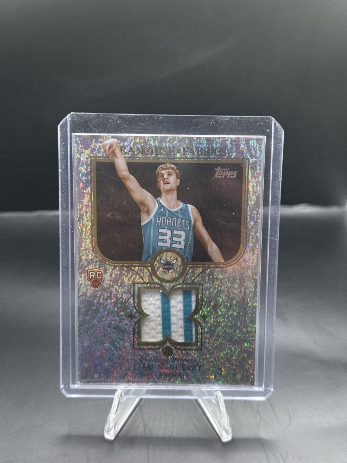 2025-26 Topps Basketball Liam McNeeley RC Franchise Fabrics Holo Foil #FF-LM SP