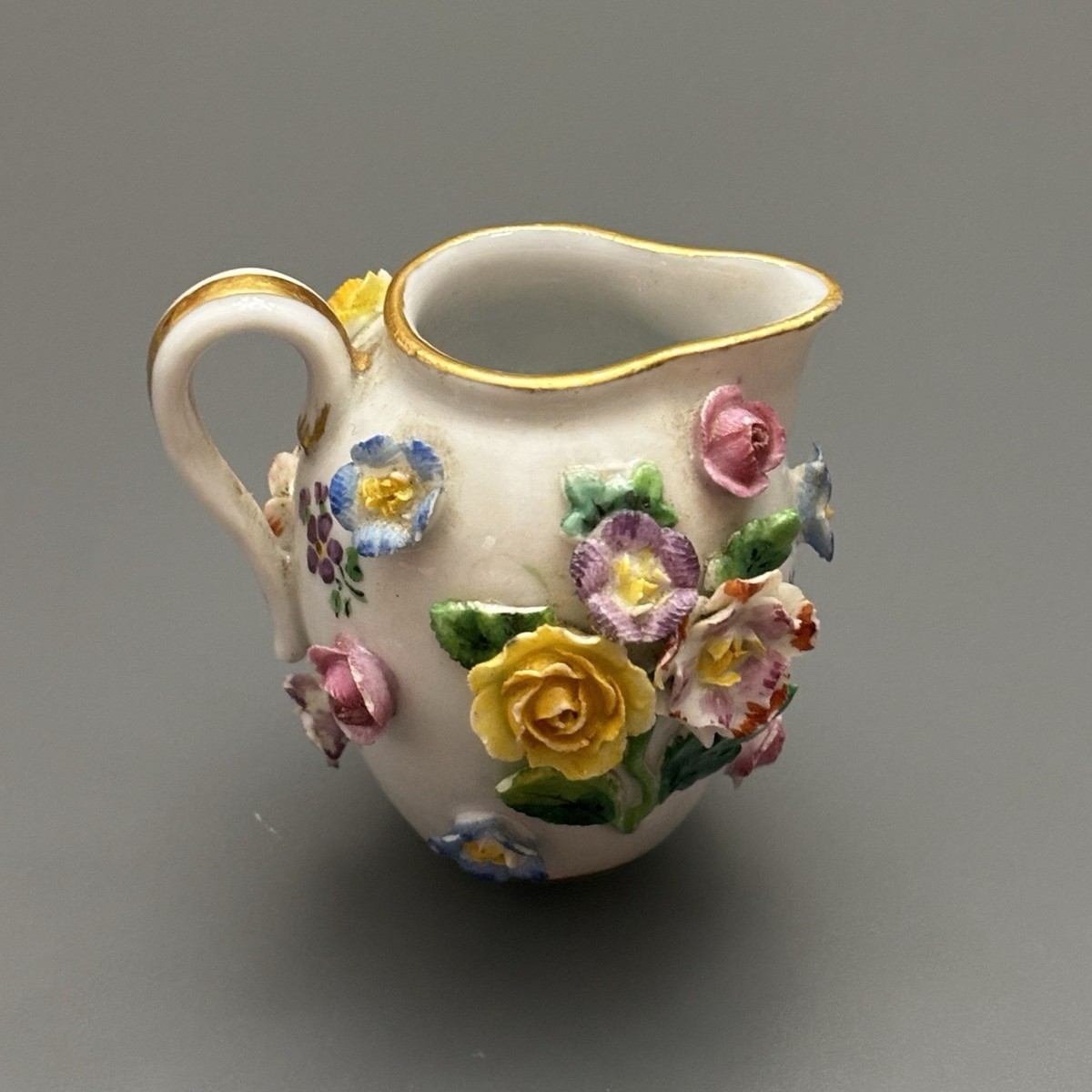 ANTIQUE MEISSEN PORCELAIN MINIATURE CREAMER ENCRUSTED WITH FLOWERS