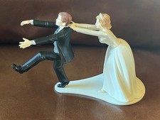 Humorous Bride Pulling Back Groom Resin/Plastic Wedding Cake Topper Figurine -