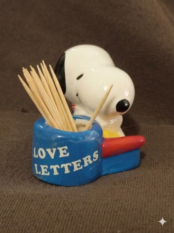 An actual 1965/66 Snoopy ceramic toothpick holder — early Peanuts merch with real mid-century provenance that doubles as a desk curiosity.