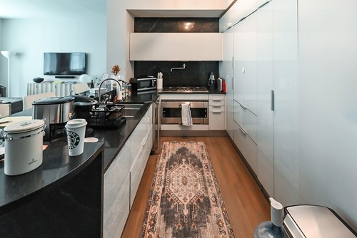 Cesar Modern Glossy White Kitchen with Black Granite Countertops & Appliances
