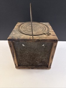 Vintage wooden cricket bait cage with wire mesh and metal lid.