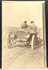 RPPC ~ Man Driving a 1910 Overland on a Dirt Road with Woman and Dog.  BB