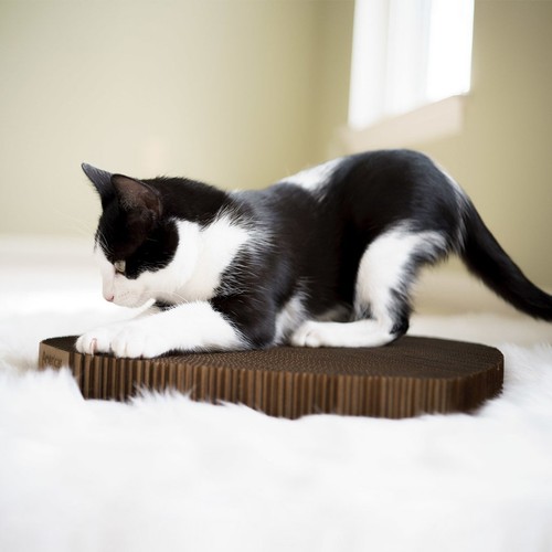 Black and white cat scratcher with textured cardboard, 17 x 10 x 1.5 inches, placed on white fur background.