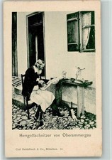 13040429 - 8103 Oberammergau Herrgottschnitzer on the doorstep at work