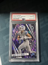 2023 Panini Phoenix - Amon-Ra St. Brown #64 Purple Seismic /125 PSA 10