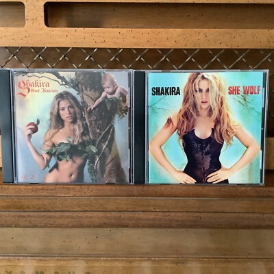 SHAKIRA CD ALBUM BUNDLE X 2 SHE WOLF & ORAL FIXATION VOL 2 CD ALBUM COVER