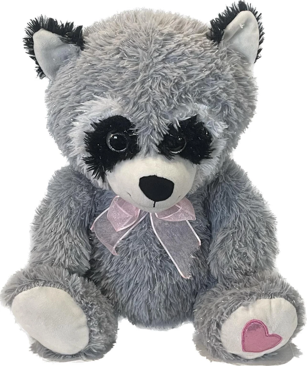 Raccoon hugging stuffed clearance animal