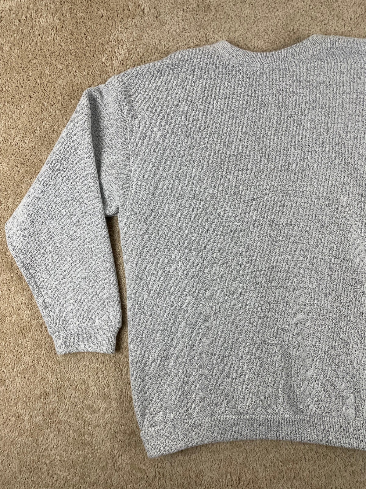 Gray vintage pullover sweater with long sleeves and textured knit, made in USA, ocean city MD, on beige carpet.