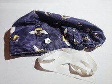 scrub cap features a navy blue fabric with a bumble bee pattern