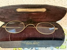 Antique gold wire-framed eyeglasses with original 'Silver Lens' branded case