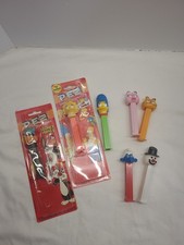 Lot of 7 PEZ Dispensers, Simpsons,Garfield,Smurff,snowman, and Looney tunes