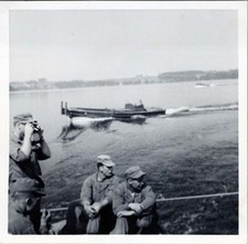 WW2 Photo Of 3 US Soldiers Watching River Boat As One Photographs