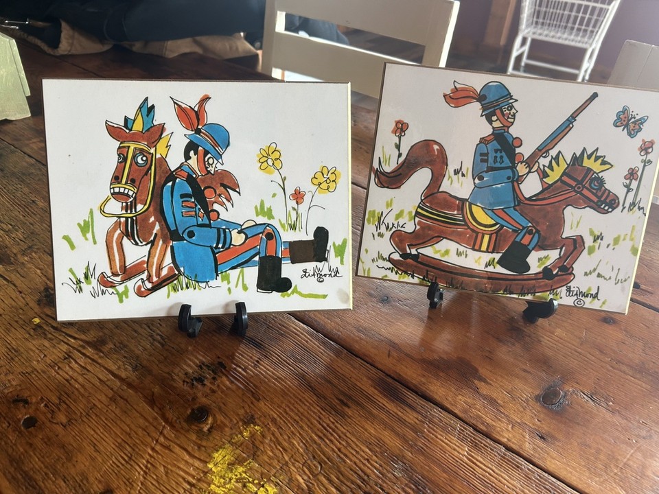 A pair of signed vintage folk art plaques featuring a whimsical soldier and horse — quirky, hand-done, and the kind of thing you'd spot at a great antique market.