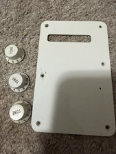 Lot of Fender Volume knobs and back cover.