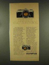 1977 Olympus OM-1 and OM-2 Cameras Ad - Status Symbol