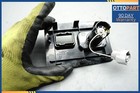 Black 2007-2012 Lexus LS460 LS460L center console auxiliary adapter with blue text label and yellow gloves.