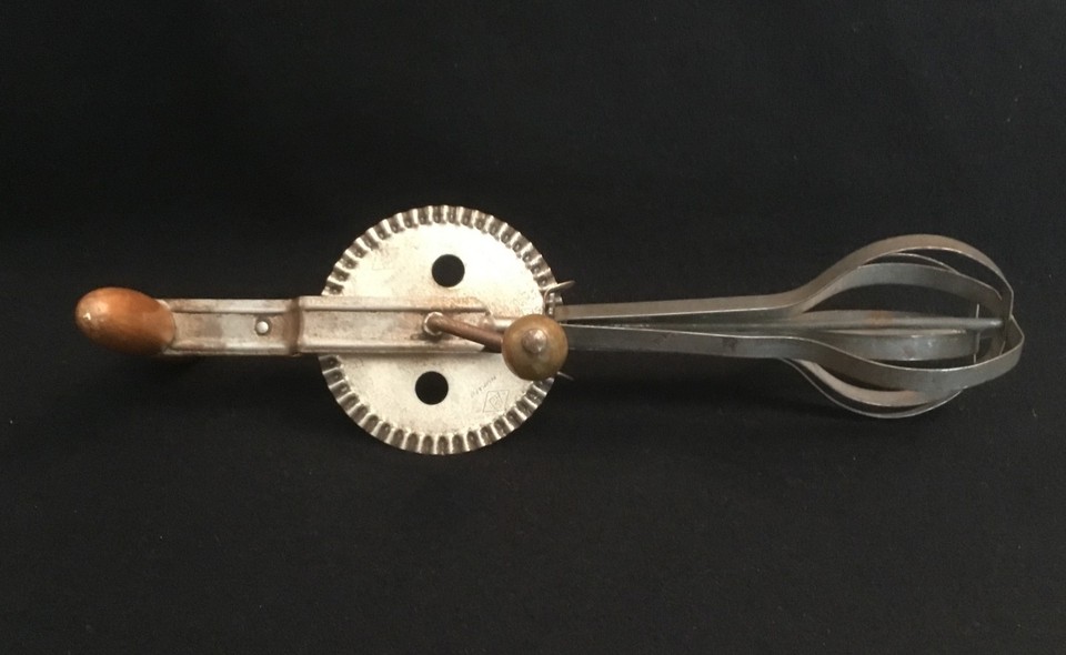 A genuine USA-made A&J hand-crank egg beater with a classic wood handle — the kind of satisfying mechanical tool that makes you want to actually bake something.