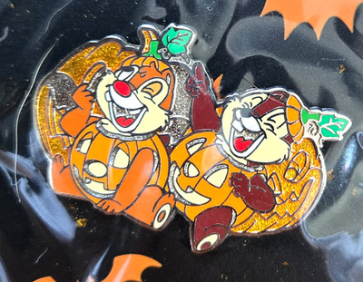 Disney trading pin featuring Chip and Dale disguised as smiling pumpkins