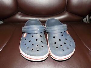 blue crocs with red stripe