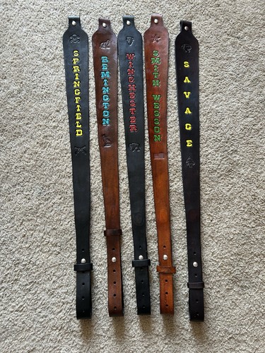 Brown leather rifle sling with black panels, gold “SPRINGFIELD,” and “SAVAGE” text.